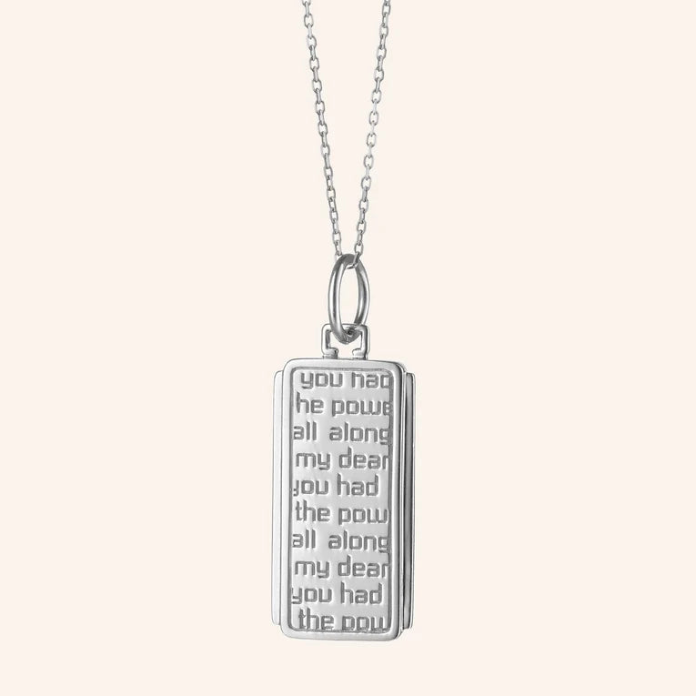 Silver pendant with engraved text on a white background
