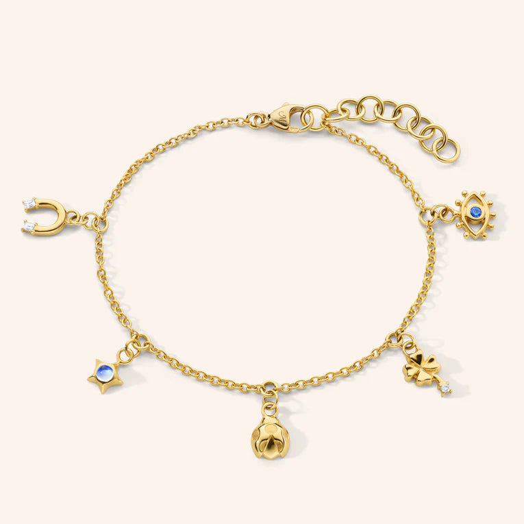 Gold bracelet with various charms on a white background