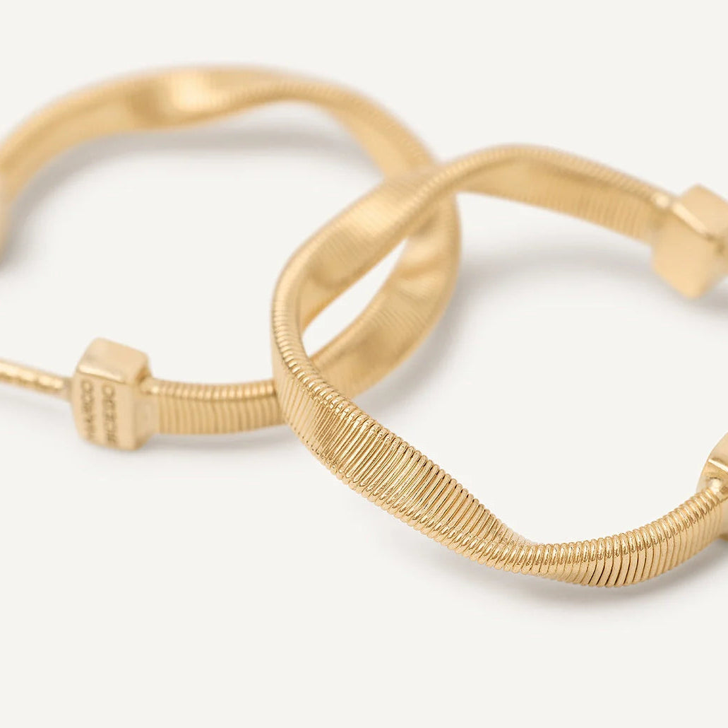 Gold hoop earrings on a white background