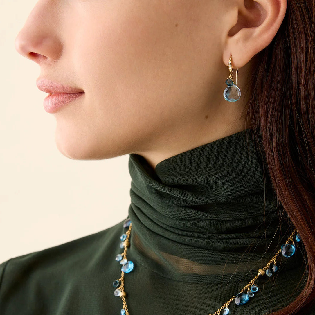 1.1" Marco Bicego Paradise Collection Blue Topaz Drop earrings with diamonds on french hook in 18ct yellow gold at Schwanke-Kasten Jewelers 4OB1955-AB_TP01_Y_02 on model